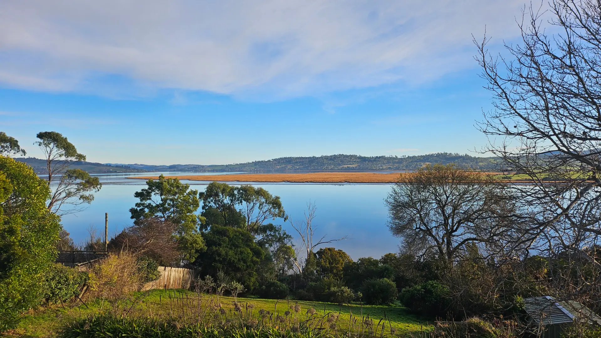 Serene landscape view of lake and hills.