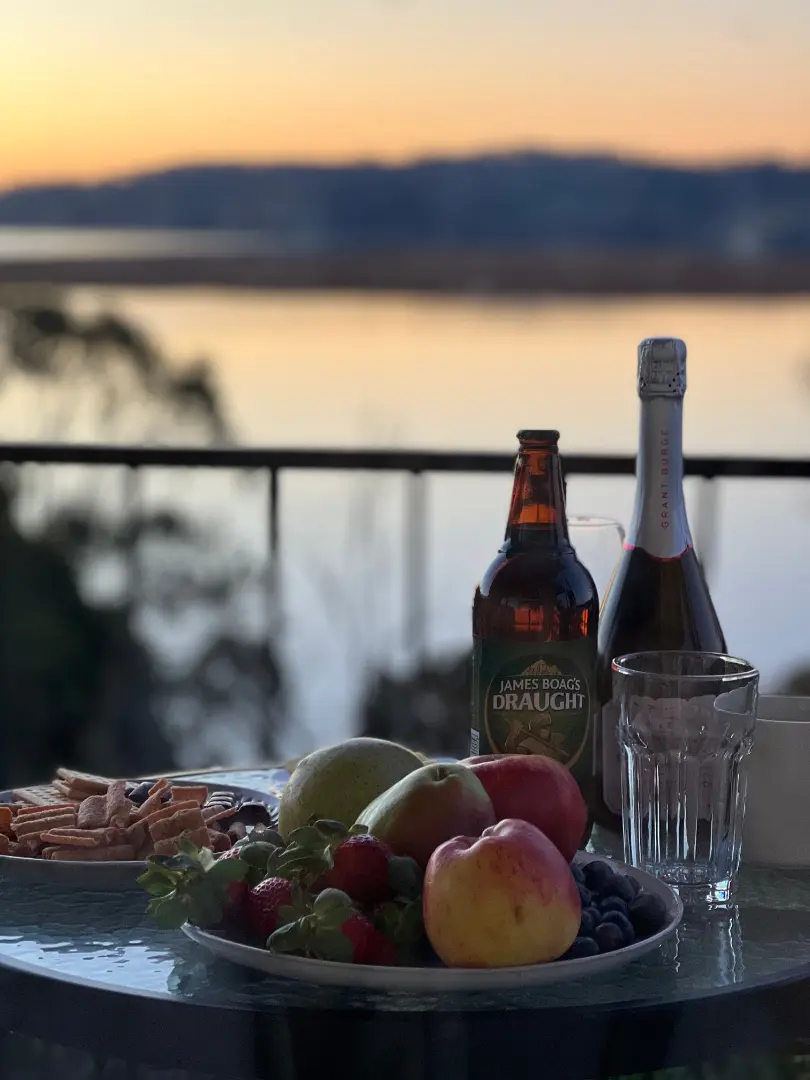 A picturesque sunset with food and drinks.
