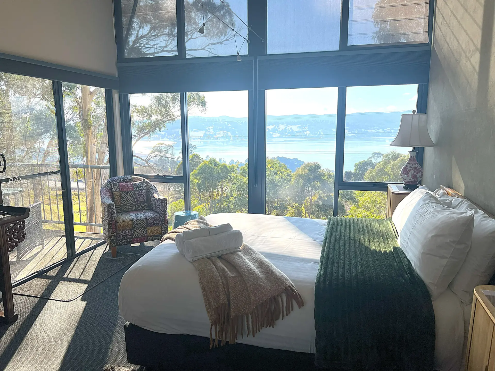 Bright bedroom with panoramic water and bushland views