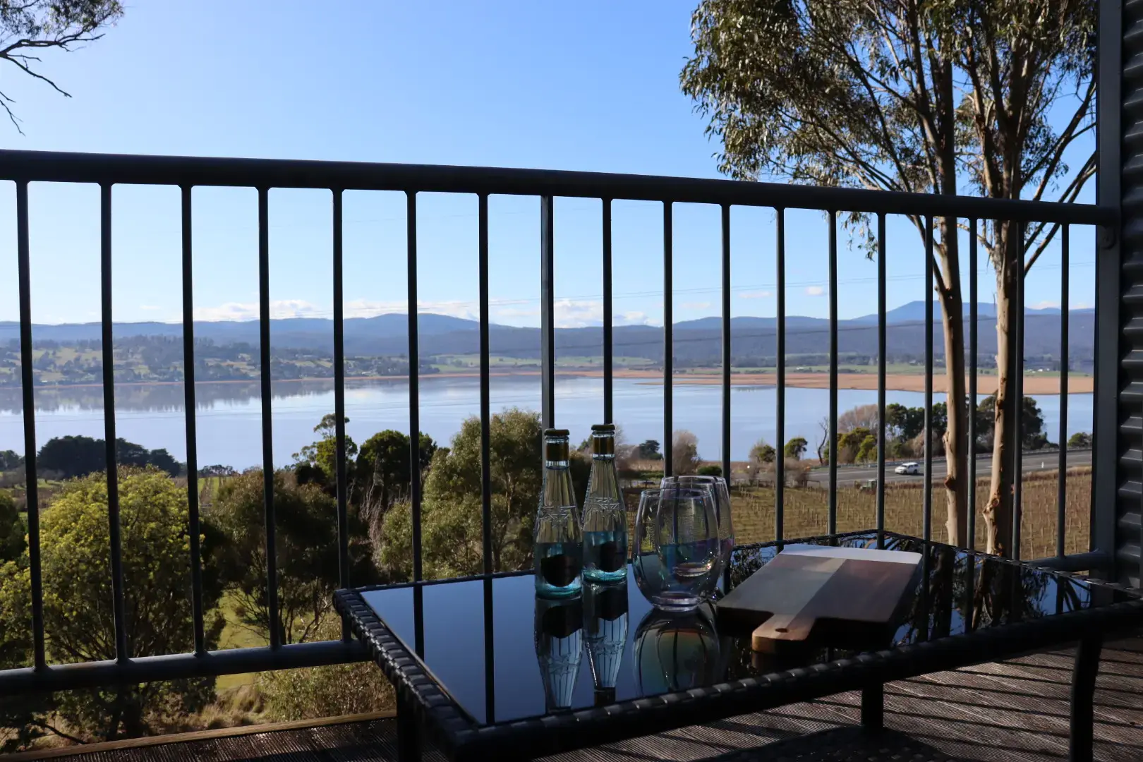 Balcony table overlooking lake and rolling hills