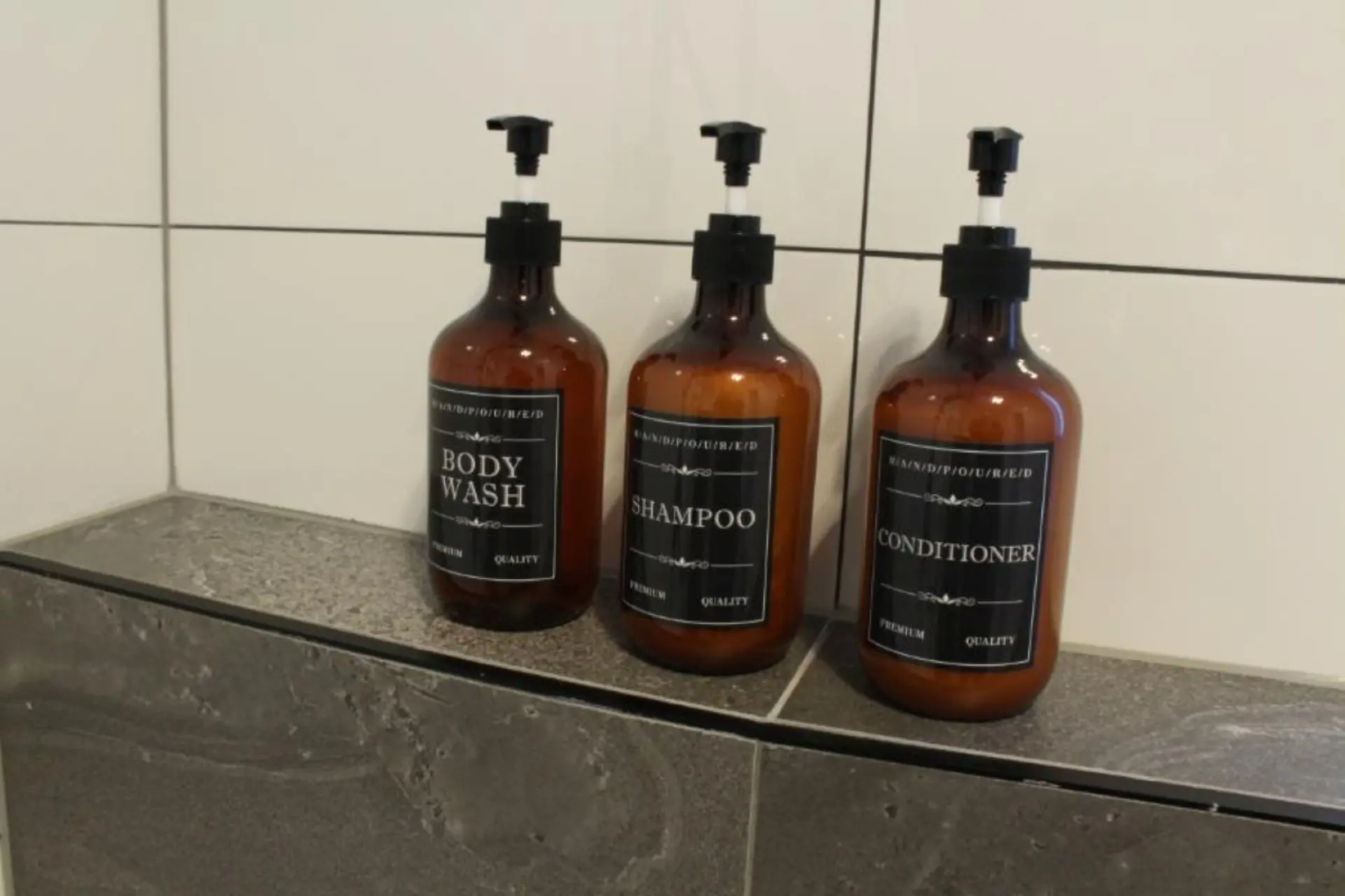 Bottles of body wash, shampoo, and conditioner.