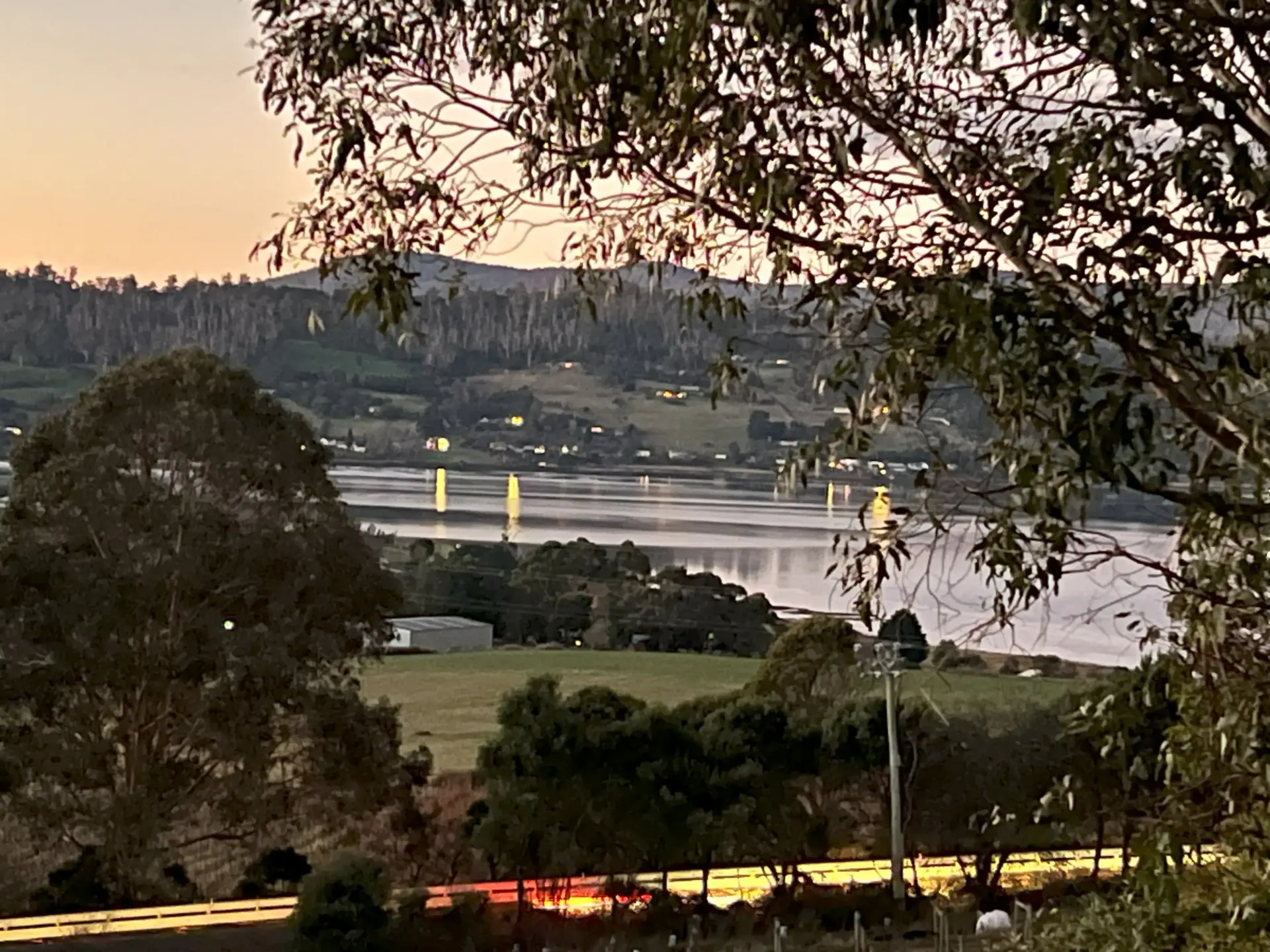 Riverside valley at dusk with hills and reflections