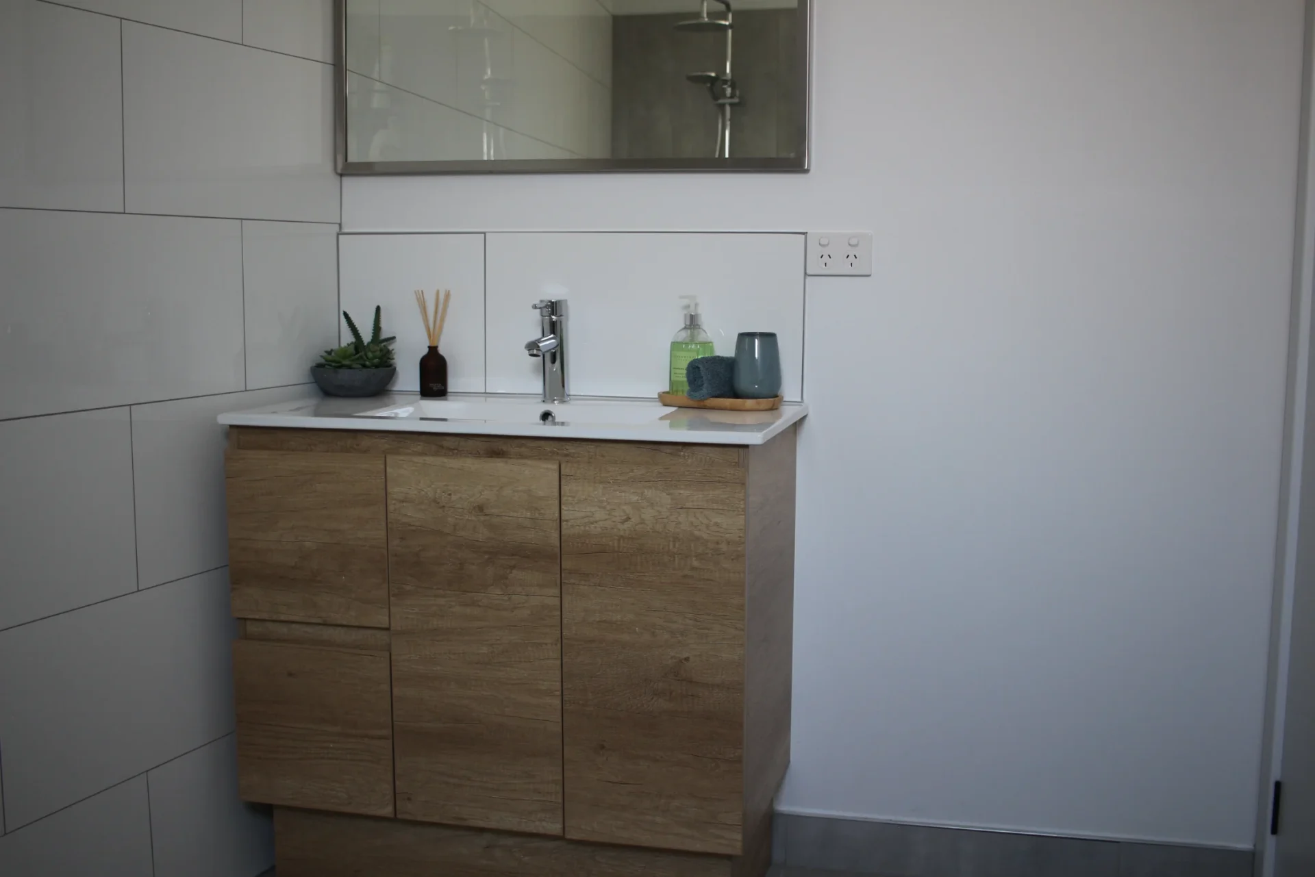 Modern bathroom cabinet with sink and mirror.