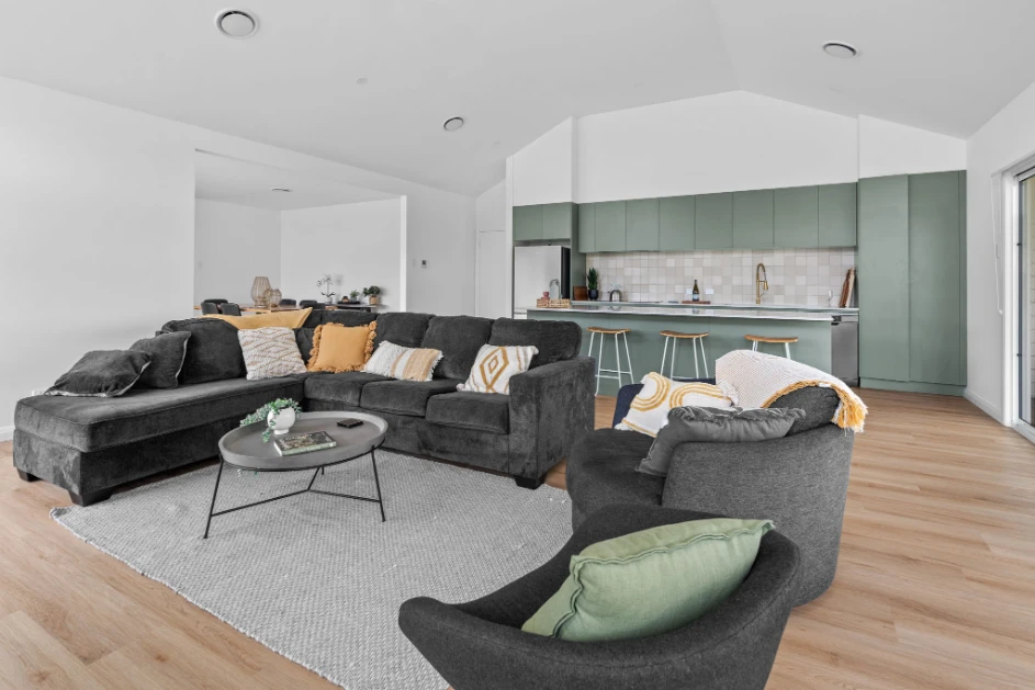 Modern living room with stylish furniture and kitchen.