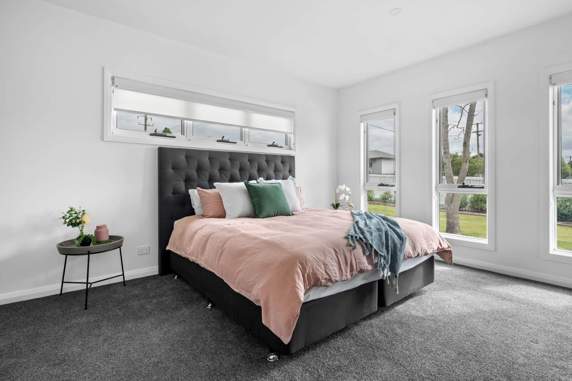 Modern bedroom with pink bedding and natural light