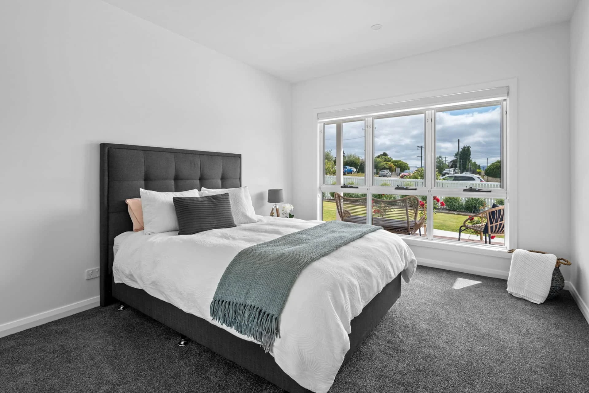 Bright bedroom with garden view and modern decor.