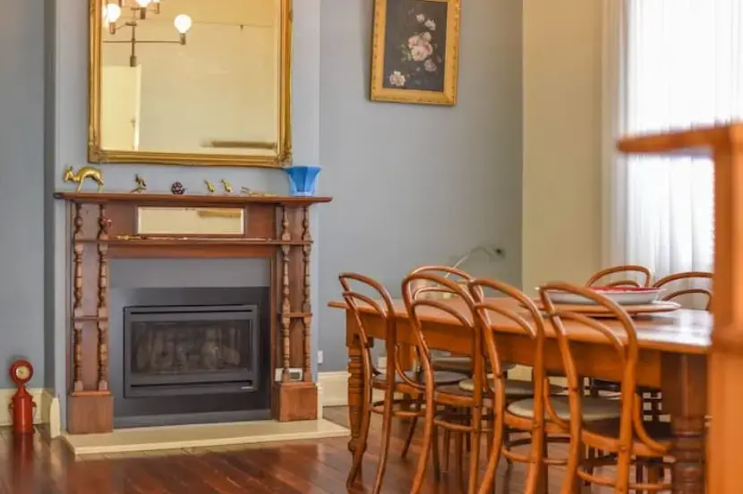 Elegant dining room with fireplace and wooden furniture
