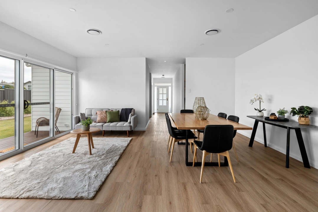 Bright modern living and dining area with wood flooring