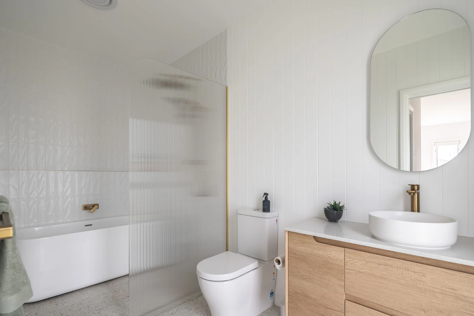 Modern bathroom with tub, shower, and vanity.