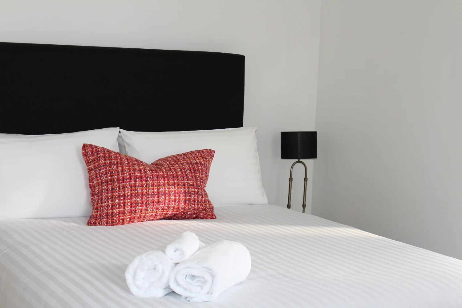 Stylish bedroom with pillows and towels