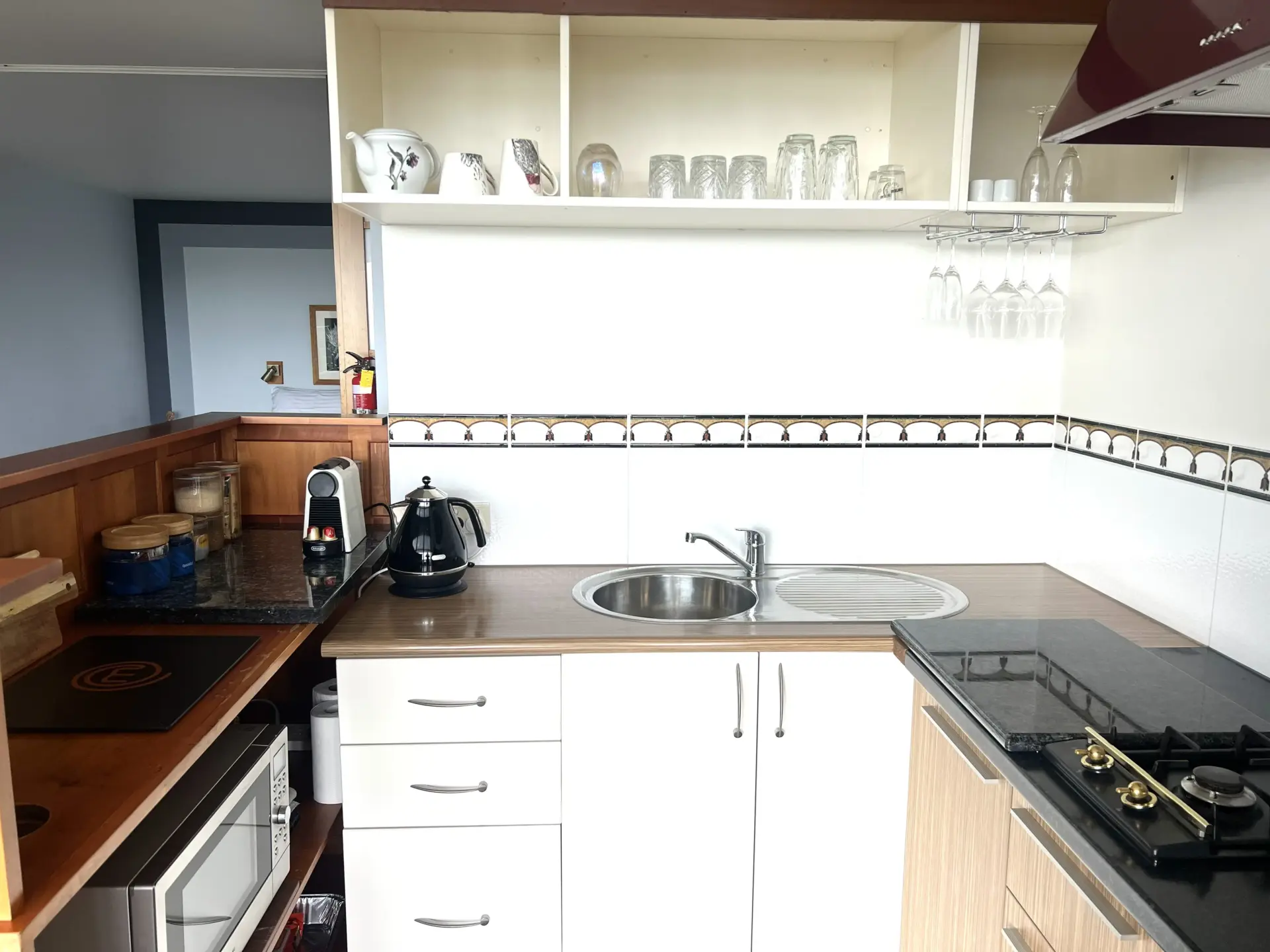 Compact modern kitchen with sink and open shelving