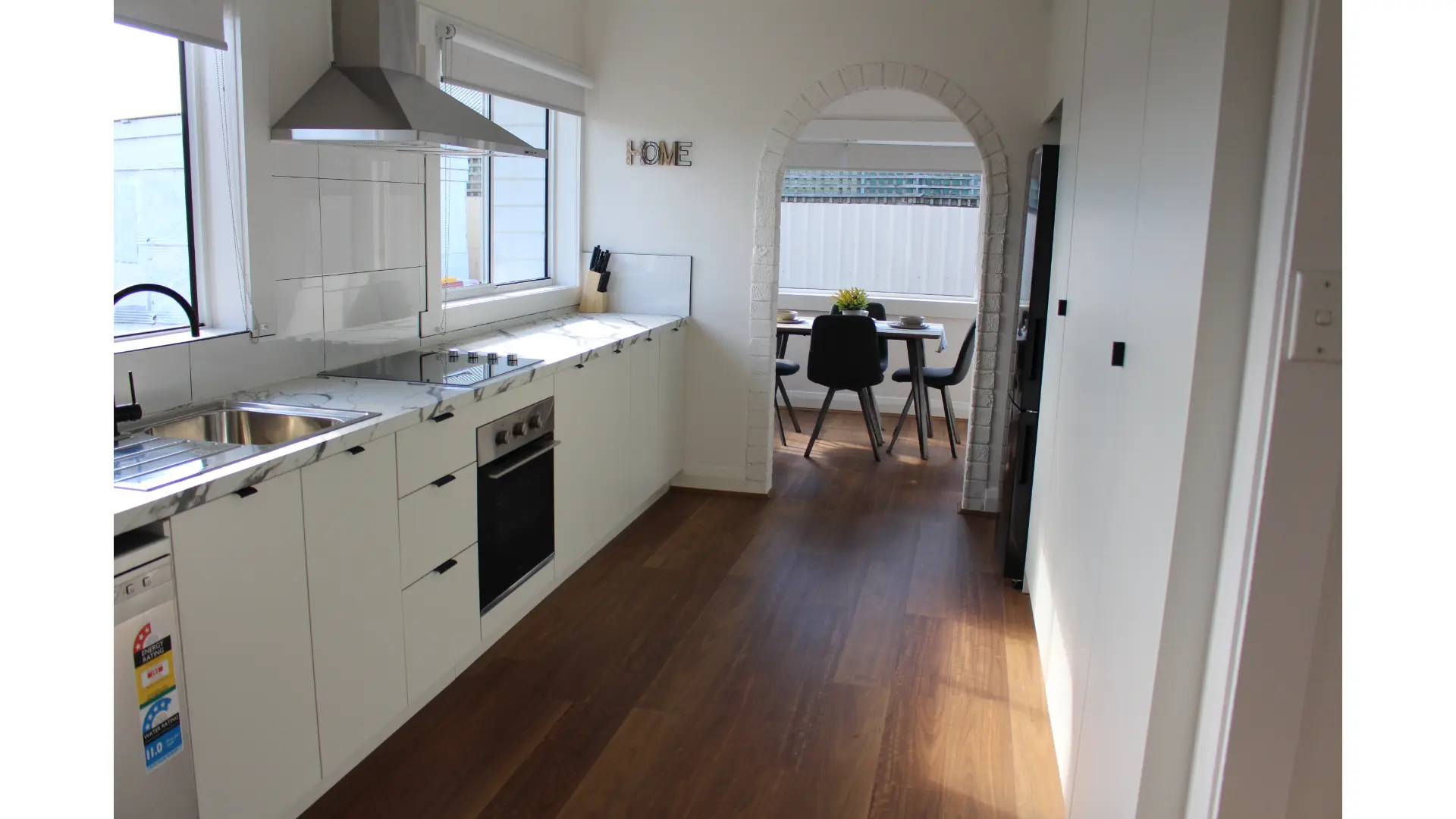 Modern kitchen with dining area visible