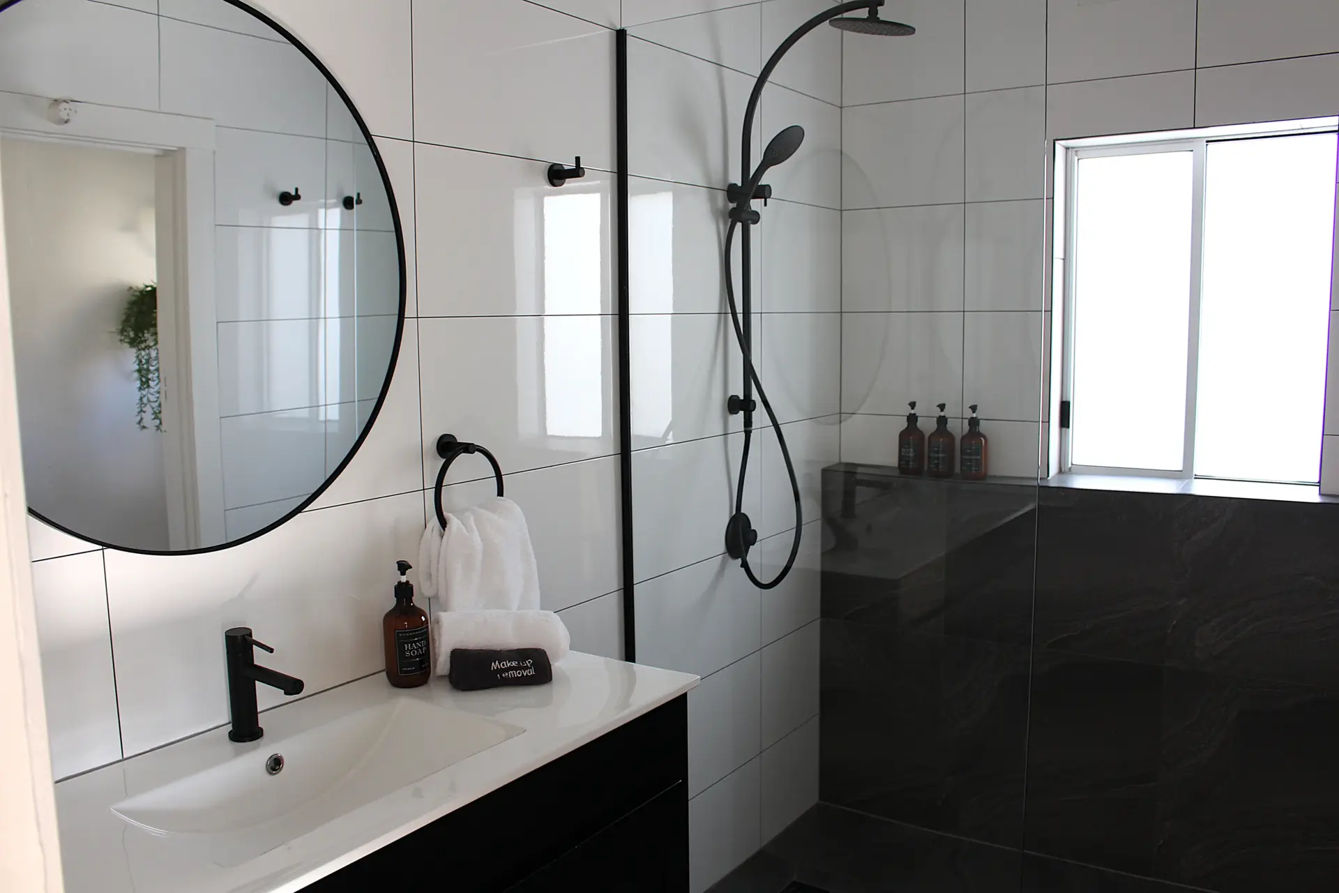 Modern bathroom with shower and accessories.