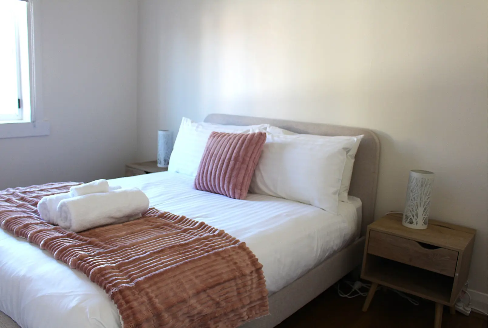 Cozy bedroom with a comfortable bed and decor.