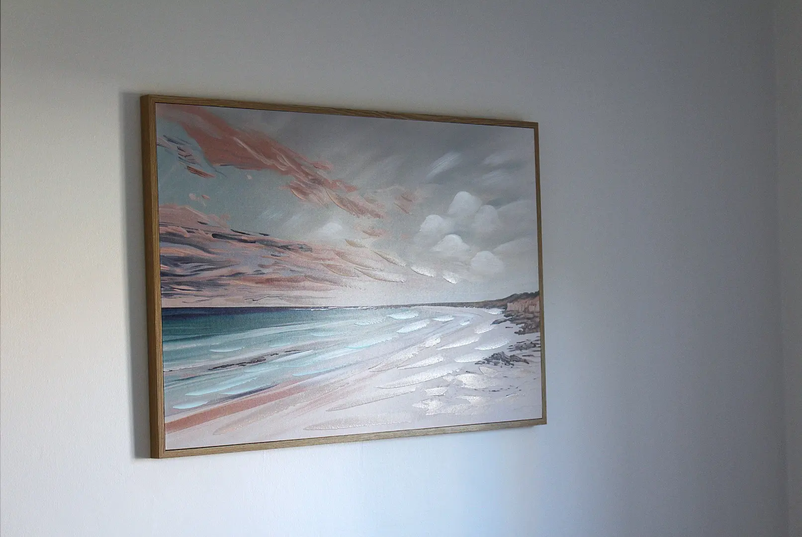 Abstract beach landscape painting on a wall.