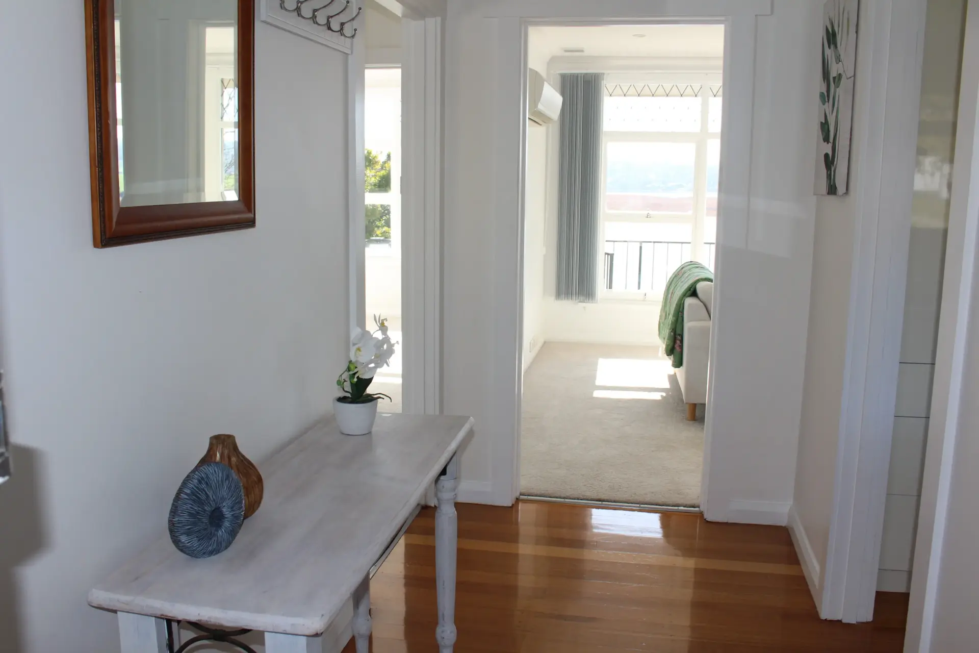 Bright hallway with decor and open rooms