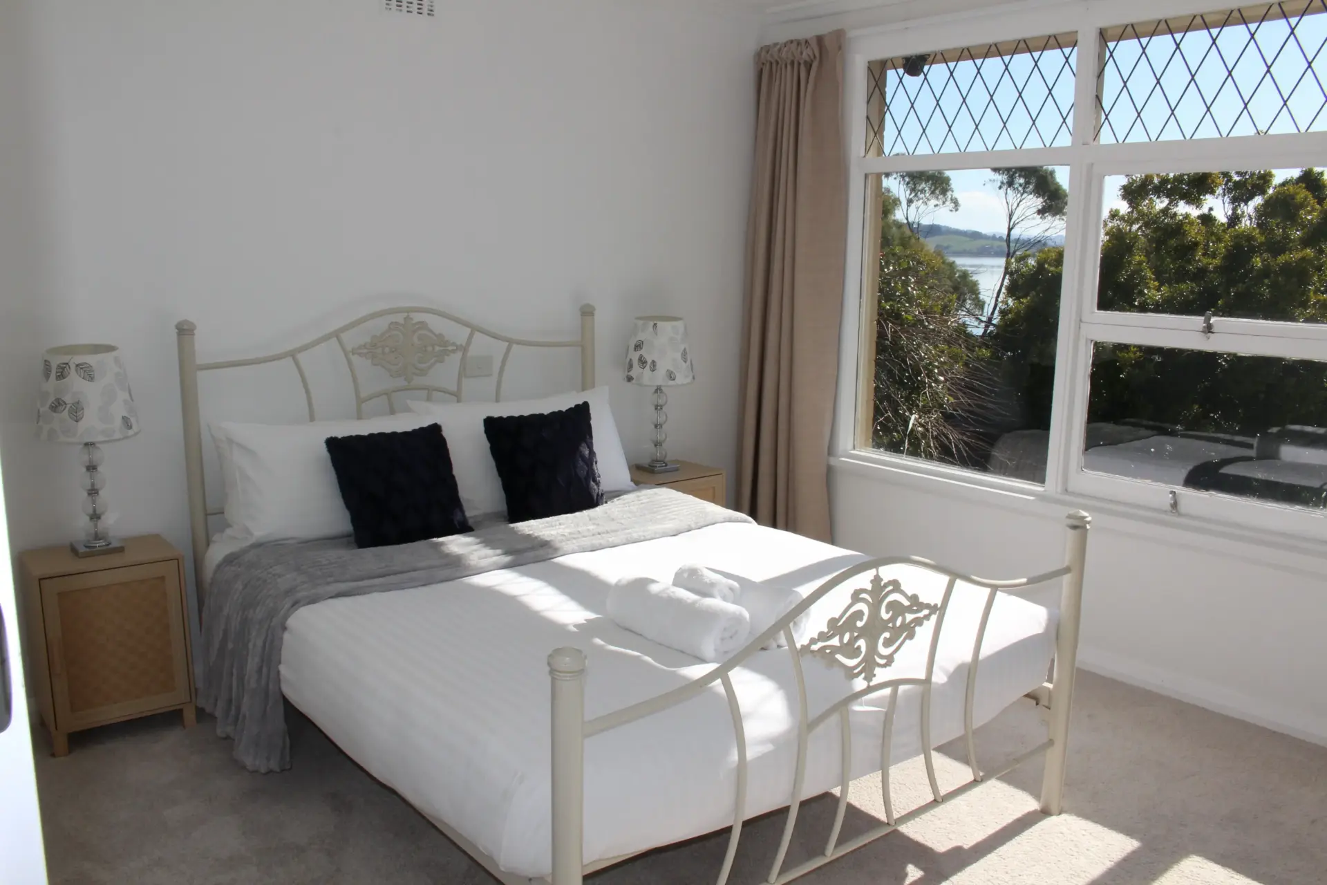 Bright bedroom with window view and stylish decor.