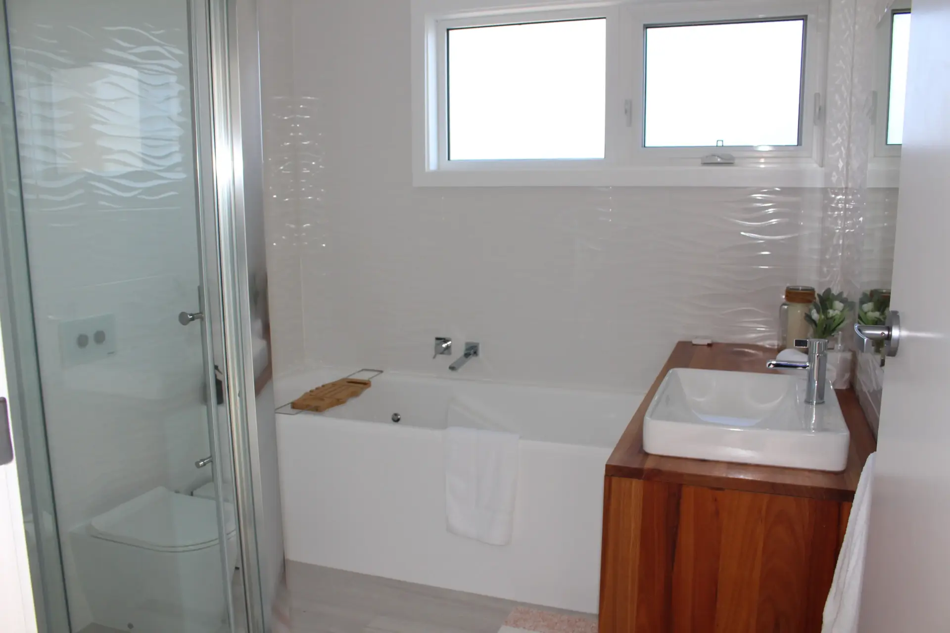 Modern bathroom featuring shower and bathtub.