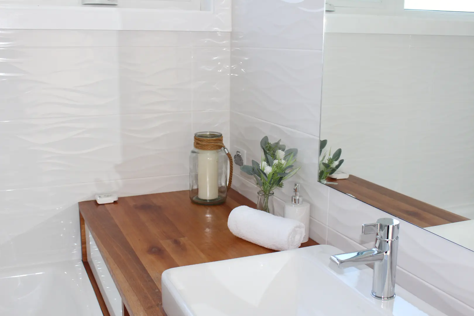 Modern bathroom with wooden countertop and decor.