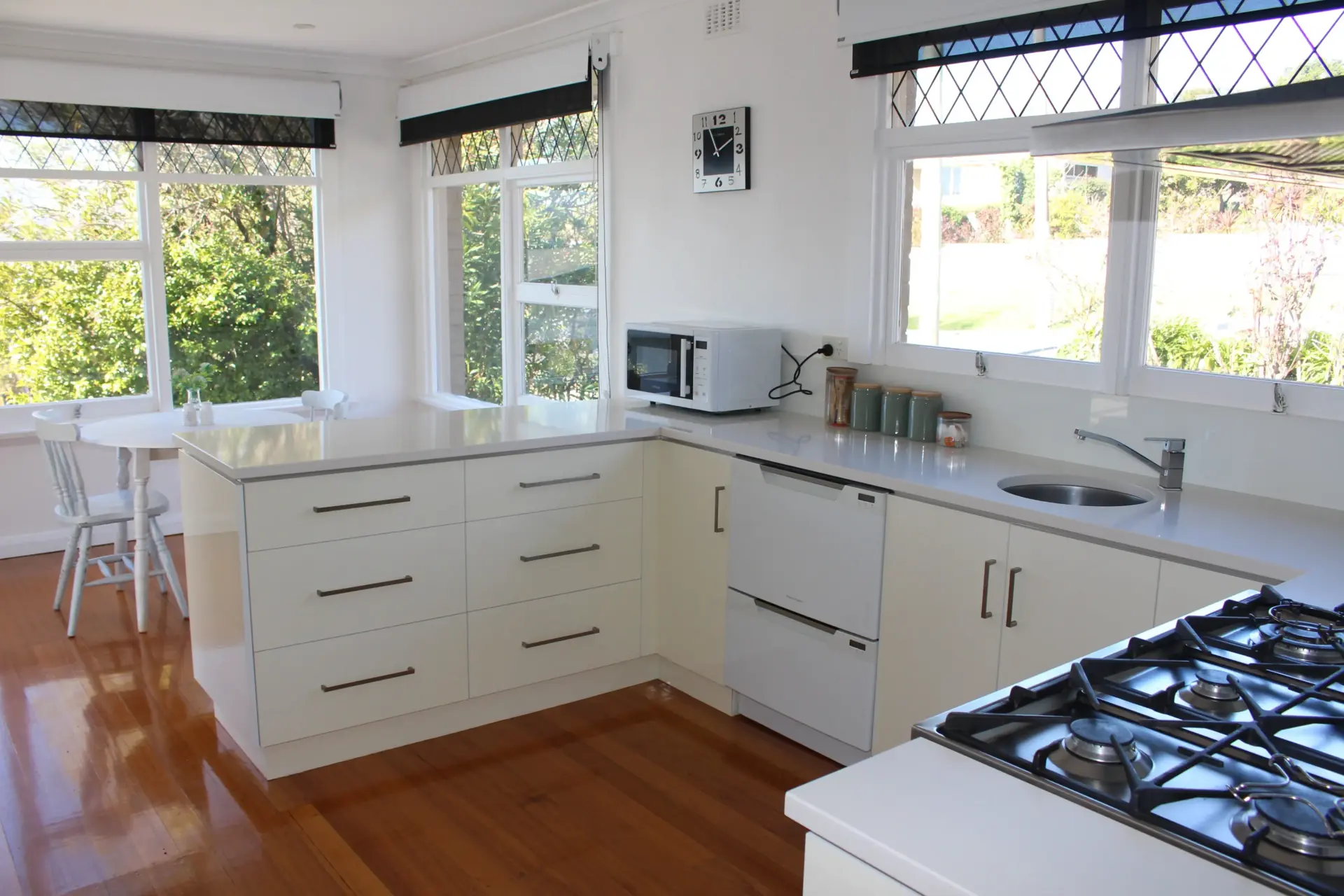 Bright modern kitchen with natural light and appliances.