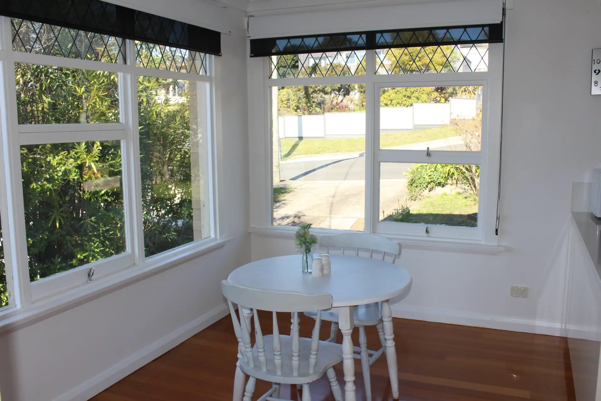 Bright dining area with round table and chairs.