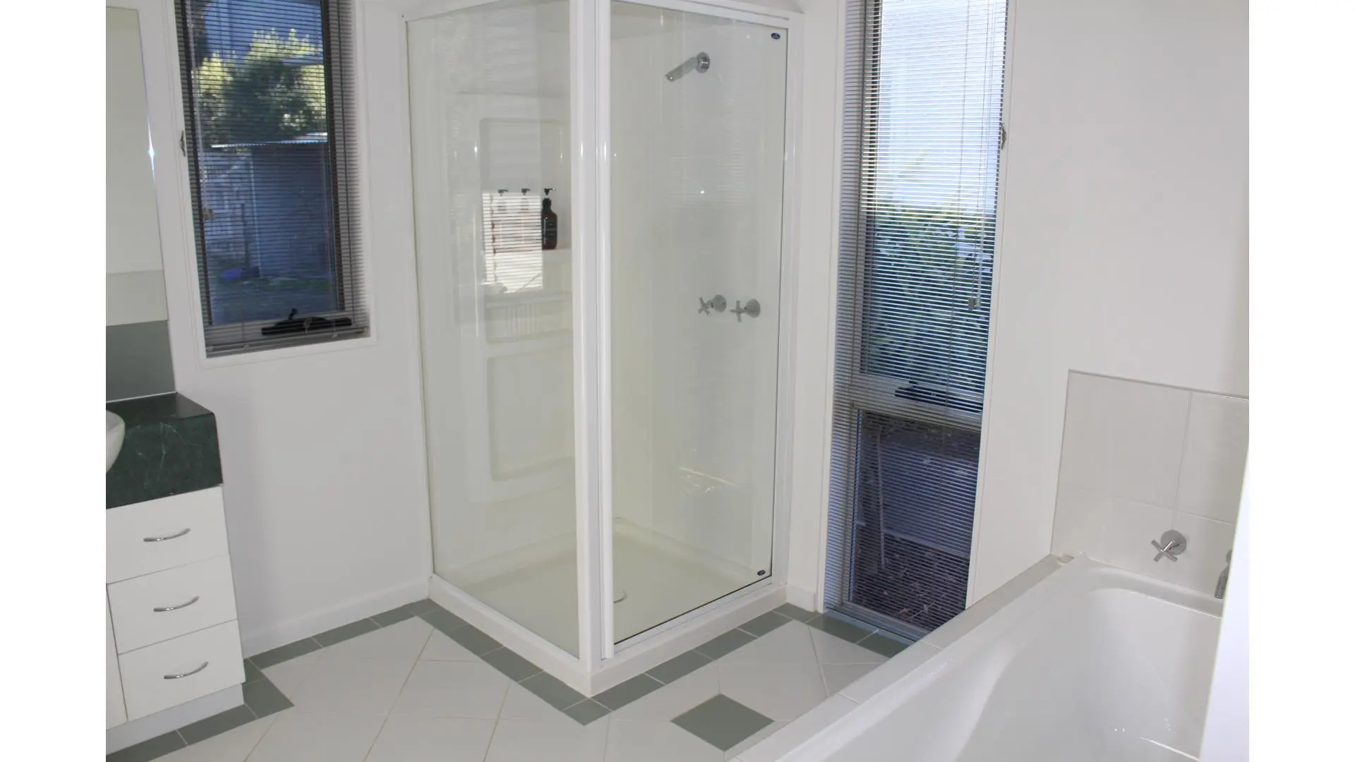 Modern bathroom with shower and bathtub features.