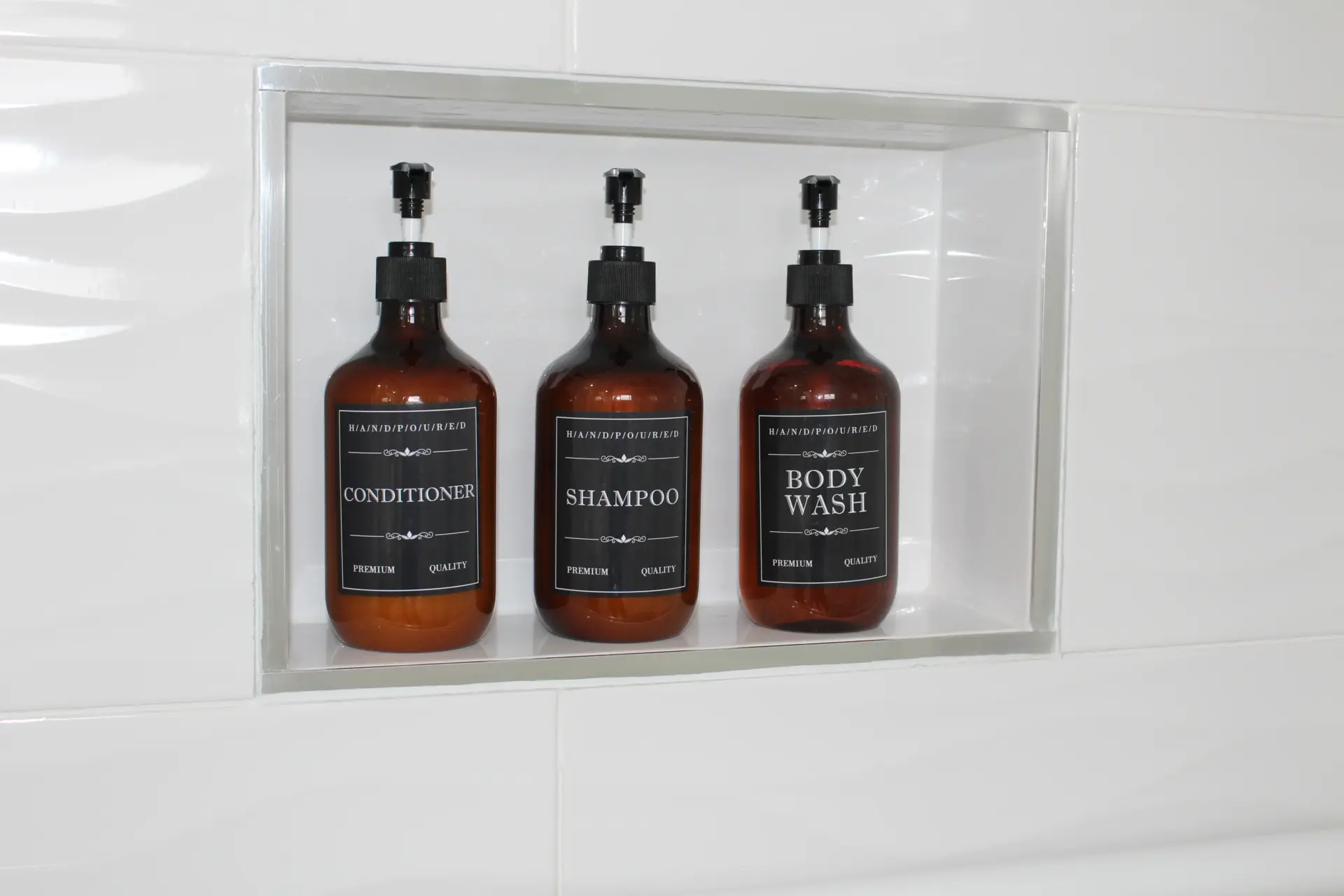 Three bottles of shampoo, conditioner, body wash