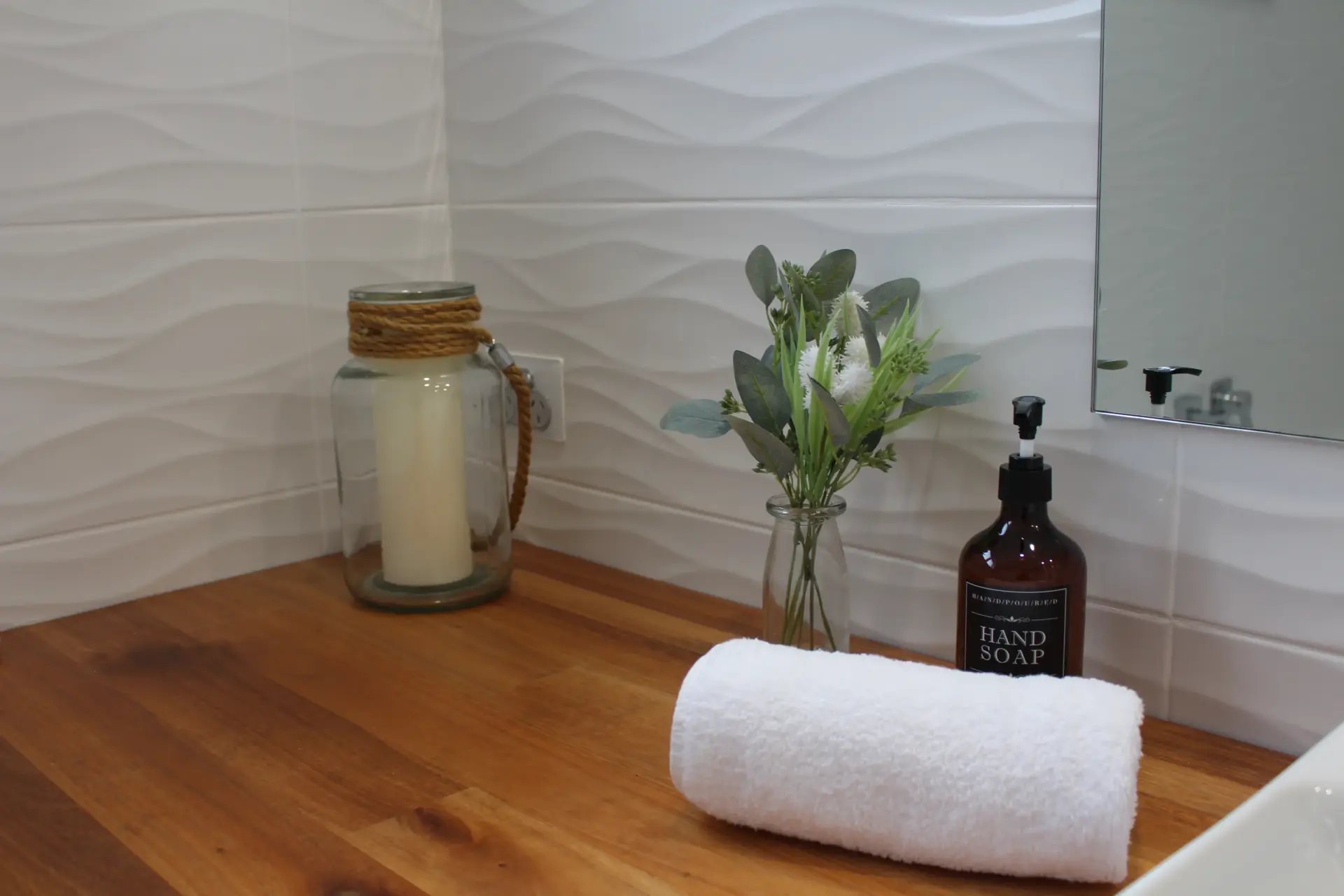 Stylish bathroom countertop with soap and towel