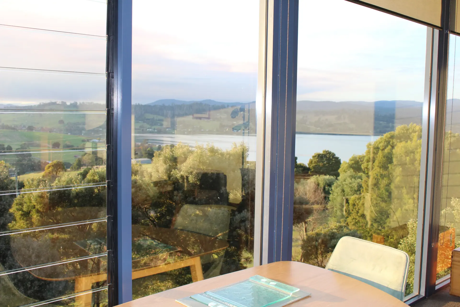 Dining table overlooking lake and rolling hills