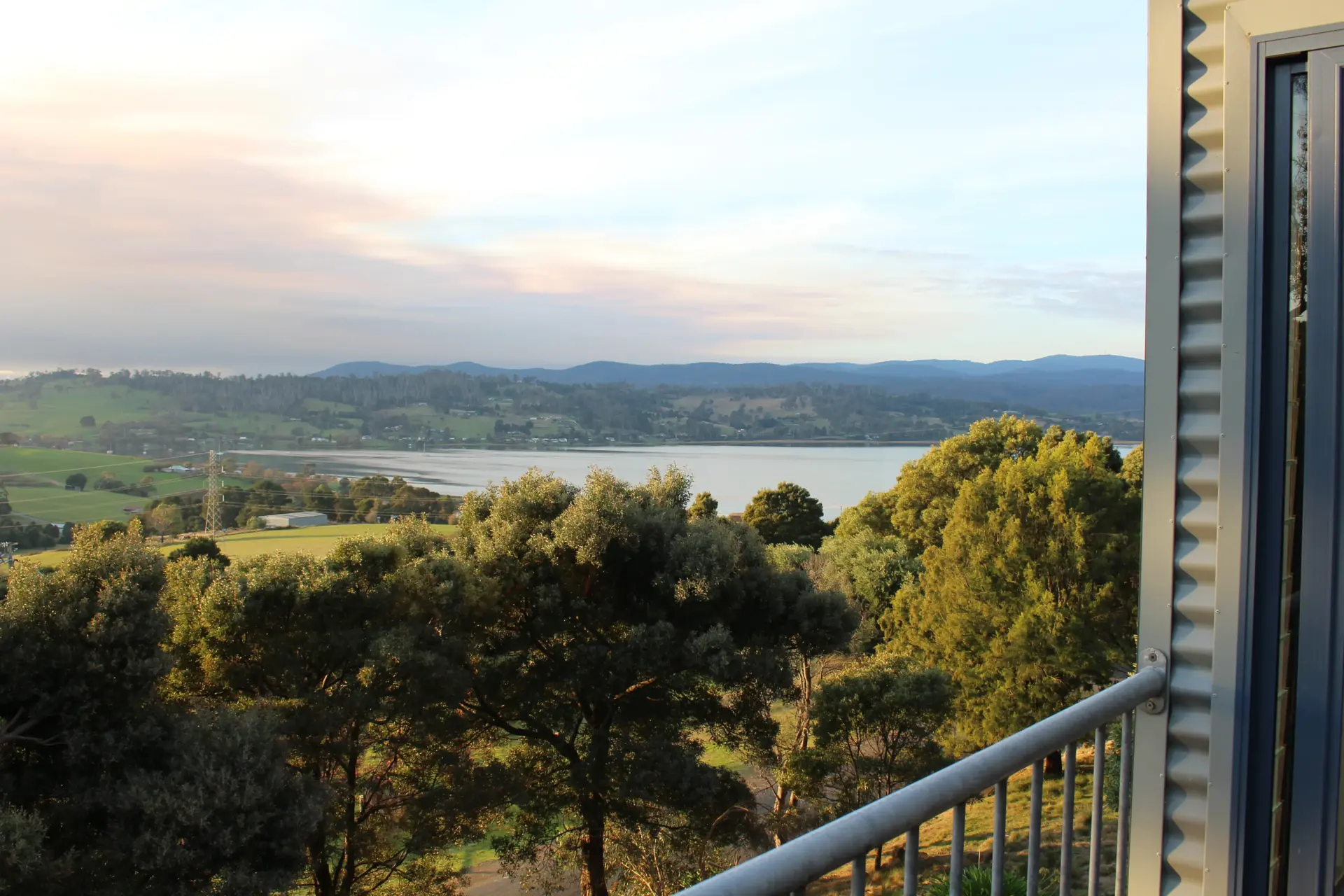 Balcony view over lake and rolling hills