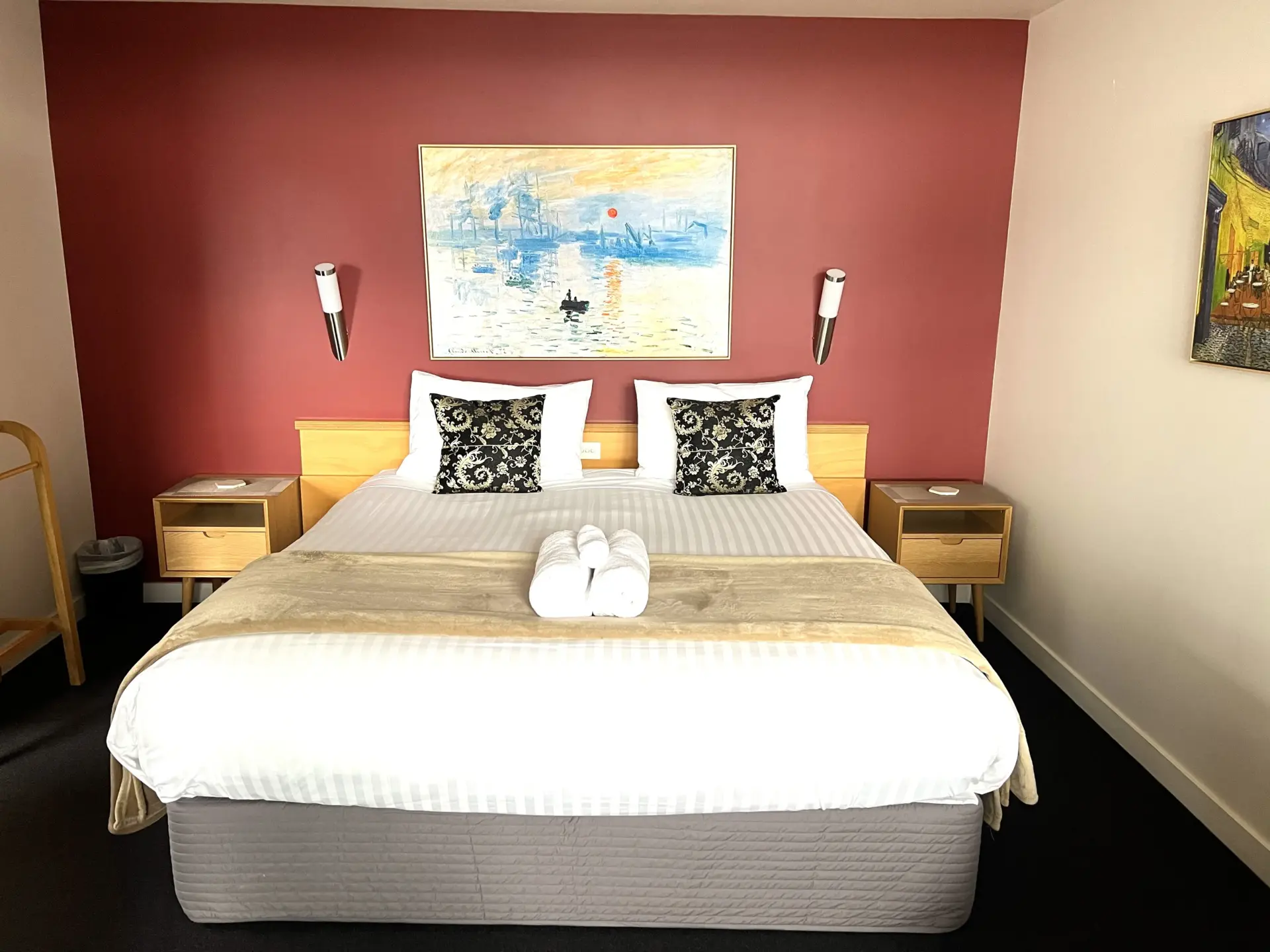 Modern hotel bedroom with red feature wall