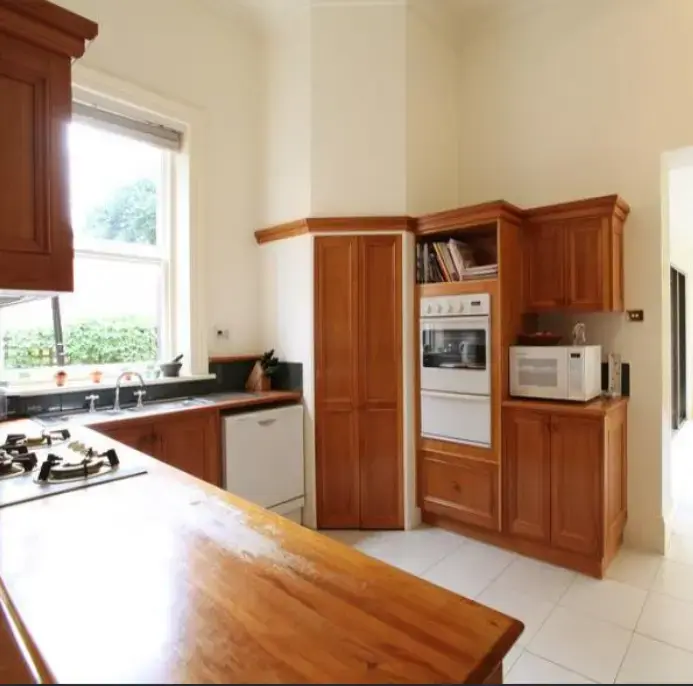 Bright kitchen with timber cabinets and large window