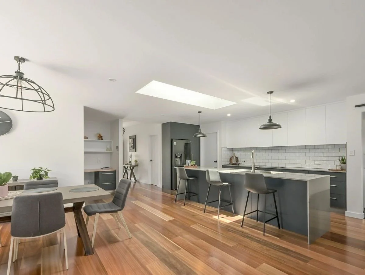 Modern kitchen and dining area with wooden floors