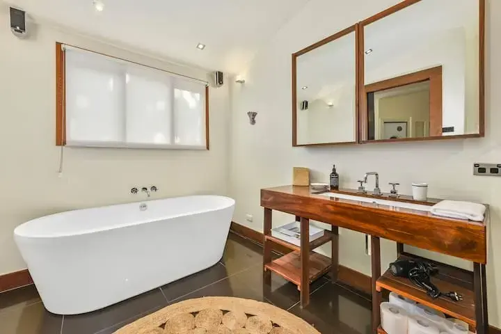 Modern bathroom with freestanding tub and wooden vanity