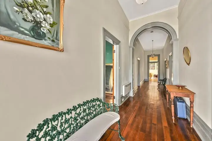 Elegant hallway with polished wooden floors and archway