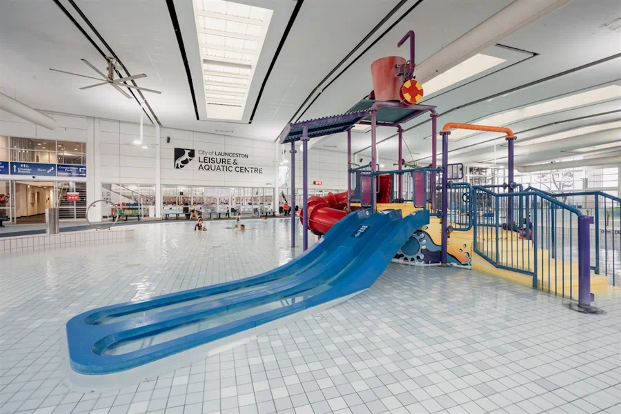 Indoor water playground with slides at aquatic centre.