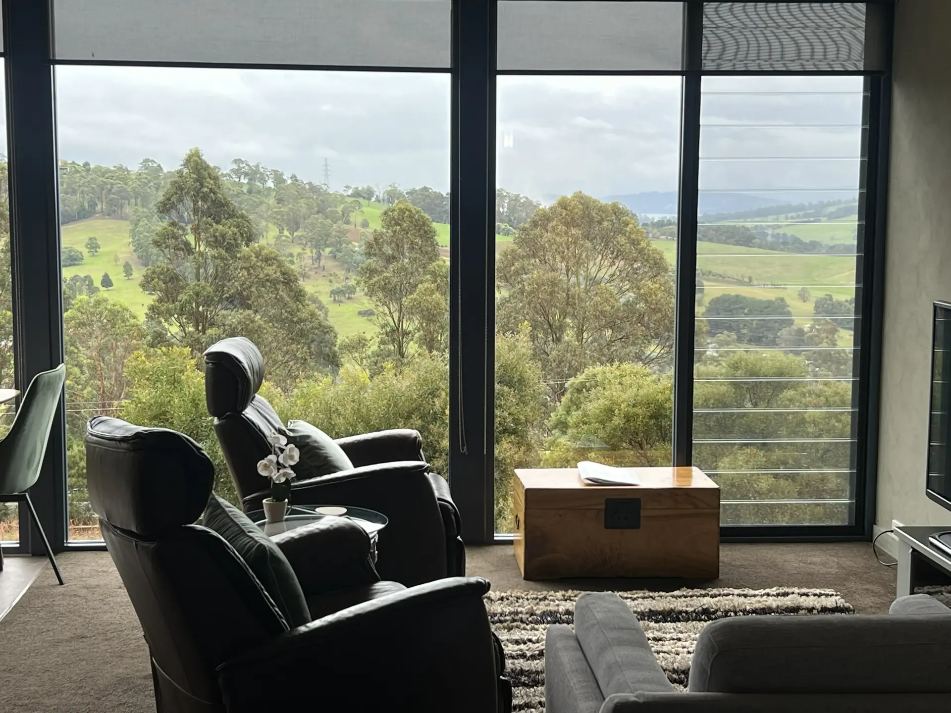 Modern living room overlooking lush green hills
