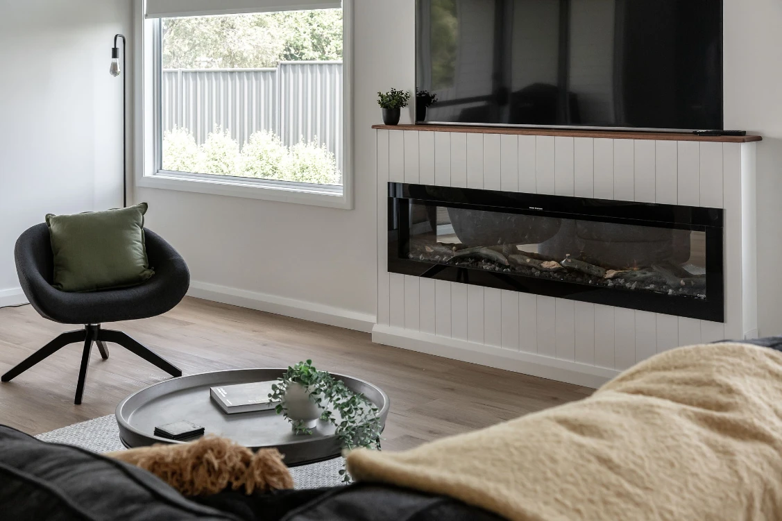 Modern living room with a stylish fireplace and window.