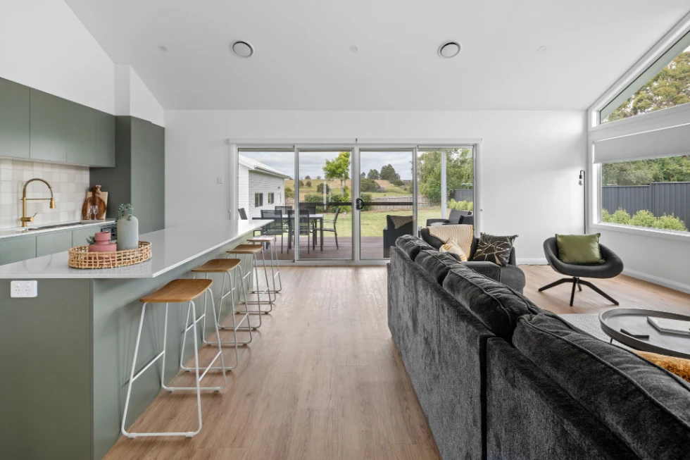 Bright, modern living area with kitchen and outdoor view.