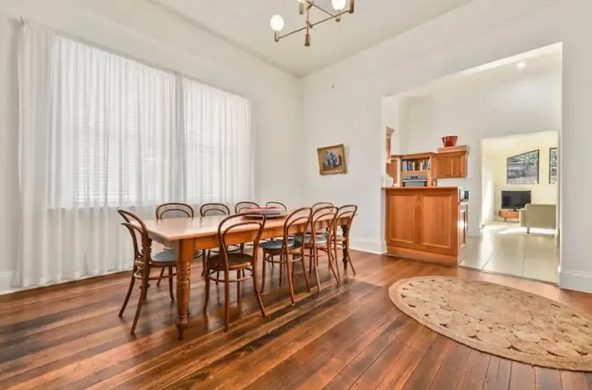Spacious dining room with table and polished floors