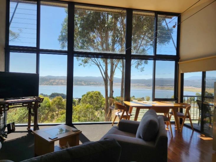 Spacious room with lake view and modern furnishings.
