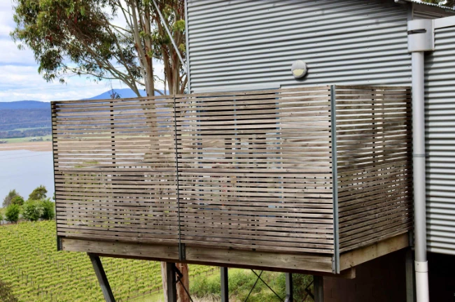 Stylish wooden balcony with scenic view.