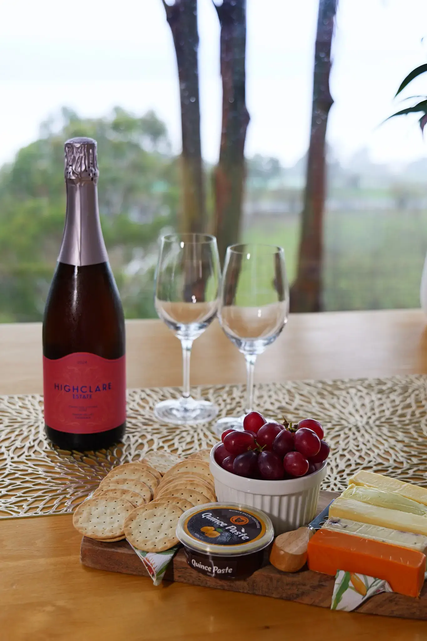 Sparkling wine and cheese platter by window
